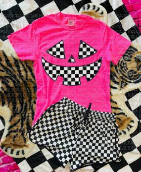 Checkered Jack o lantern on neon pink graphic tee